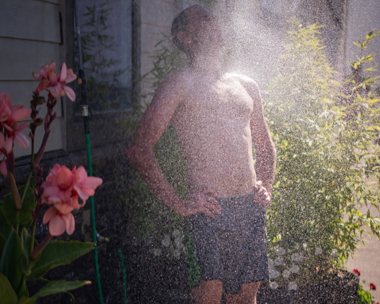 A member at the outdoor shower after class.