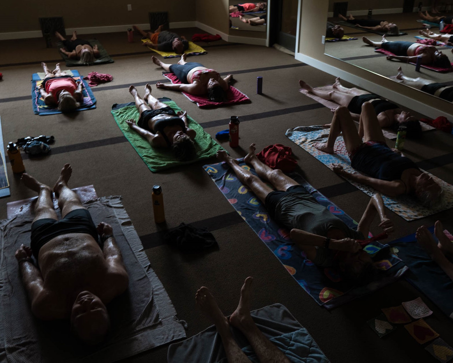 Students resting in the dim, quiet practice room.