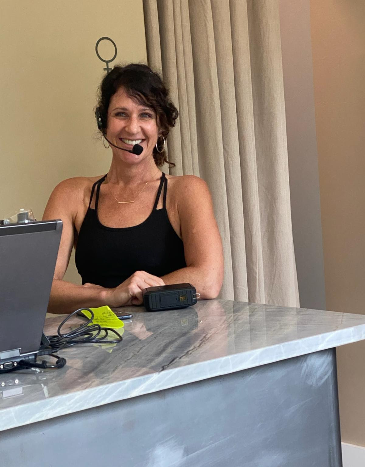 The Pilates instructor smiling mid-class.